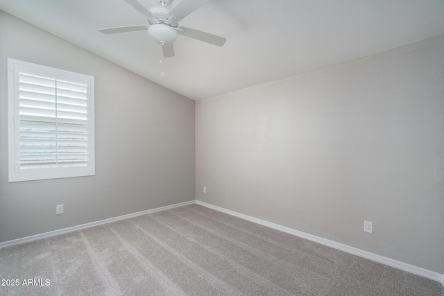 carpeted empty room featuring lofted ceiling and ceiling fan