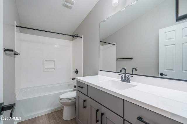 full bathroom with vanity, hardwood / wood-style floors, bathing tub / shower combination, and toilet