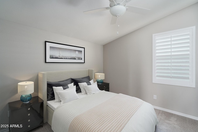 bedroom with ceiling fan, lofted ceiling, and carpet floors