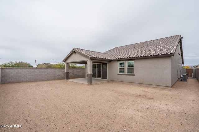 rear view of house featuring central AC unit and a patio