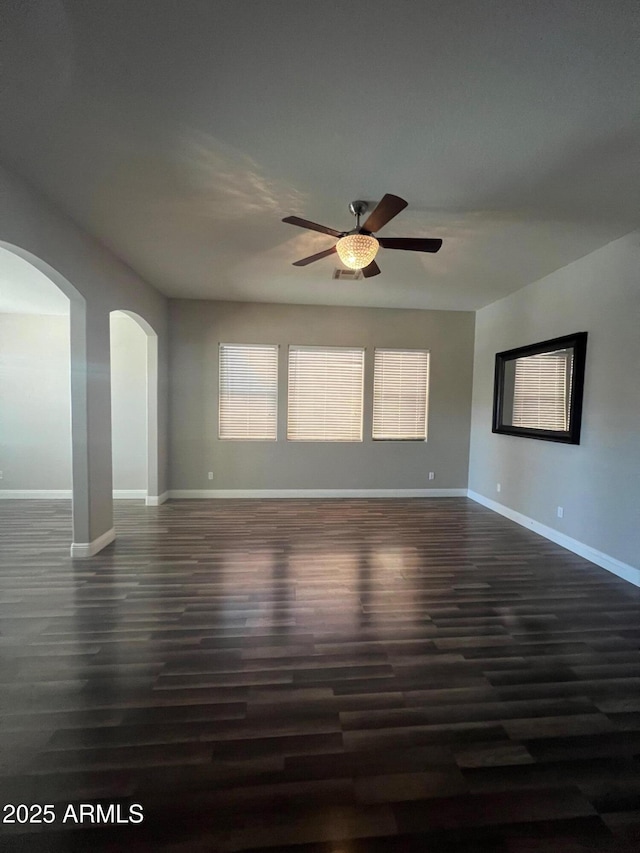 spare room with ceiling fan and dark hardwood / wood-style flooring