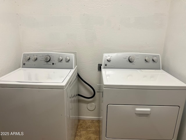 washroom with light tile patterned flooring and washing machine and clothes dryer
