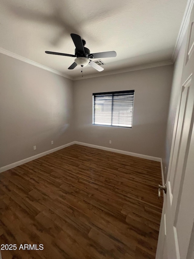 empty room featuring crown molding, dark wood-type flooring, and ceiling fan