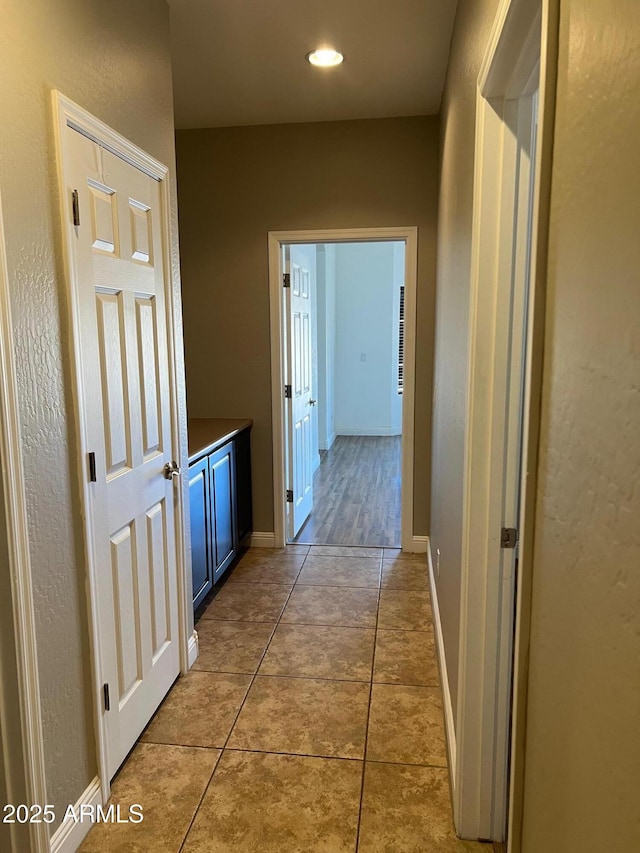 corridor with light tile patterned floors
