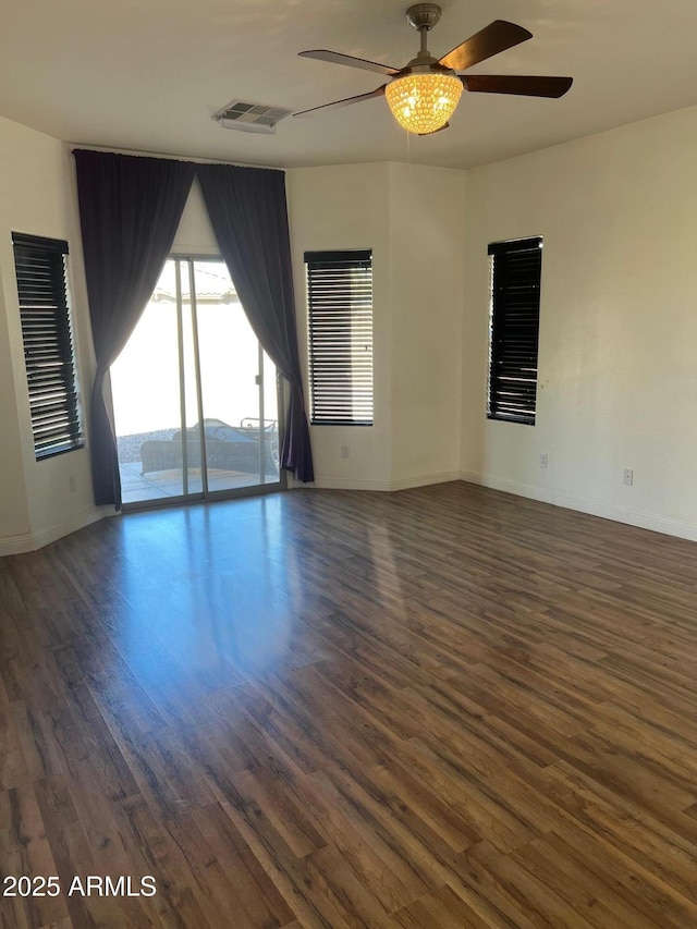 empty room featuring dark hardwood / wood-style floors and ceiling fan