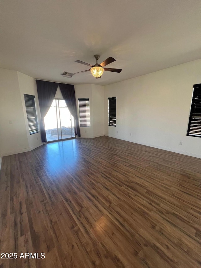 unfurnished room with dark wood-type flooring and ceiling fan