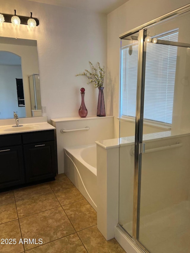 bathroom with vanity, tile patterned floors, and shower with separate bathtub