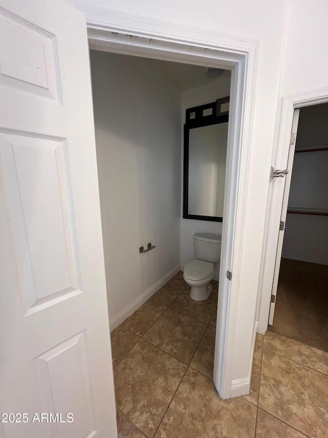 bathroom with tile patterned floors and toilet