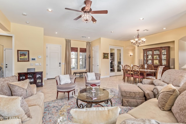 living area with light tile patterned floors, arched walkways, visible vents, and recessed lighting