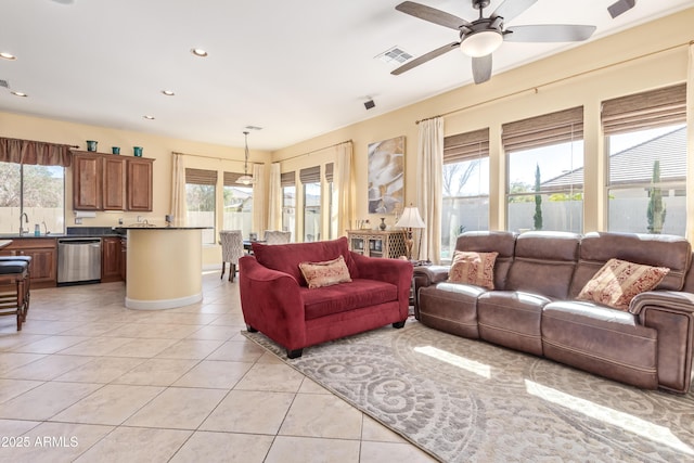 living area with a healthy amount of sunlight, recessed lighting, visible vents, and light tile patterned flooring