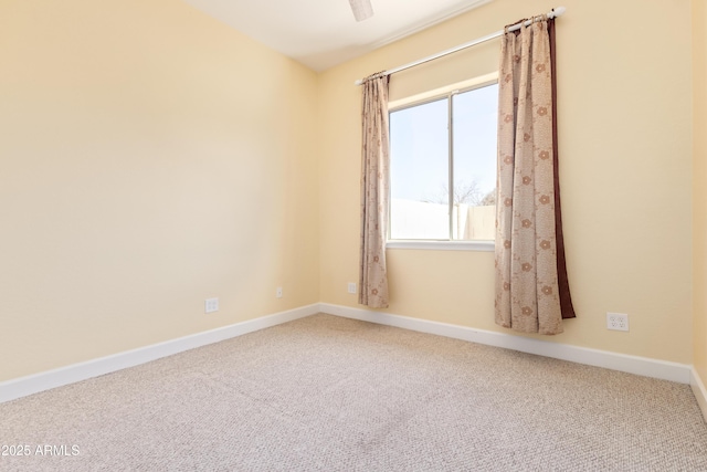 unfurnished room featuring carpet floors and baseboards