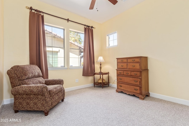 sitting room with carpet, a ceiling fan, and baseboards