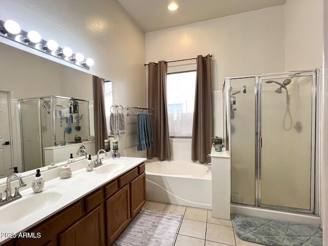 bathroom featuring a stall shower, a sink, and tile patterned floors