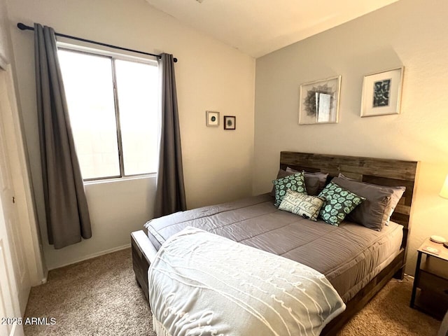 carpeted bedroom featuring lofted ceiling