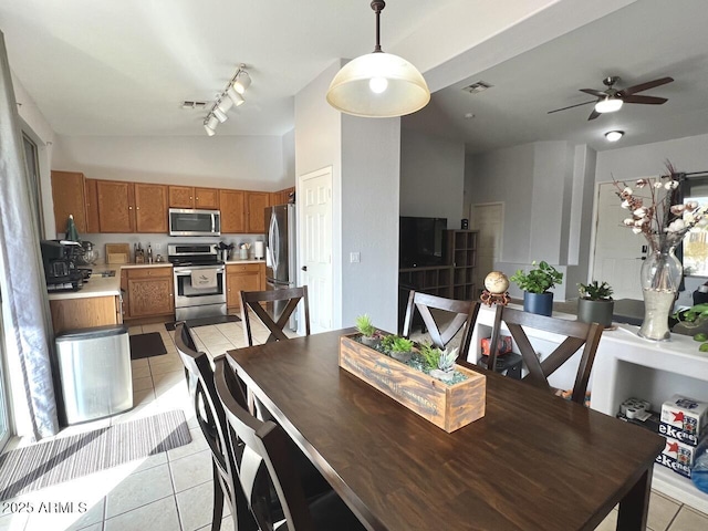 dining area featuring light tile patterned floors, track lighting, visible vents, and a ceiling fan