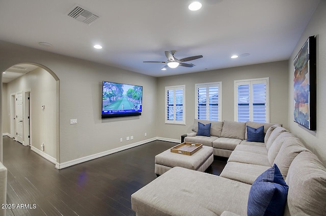 living area with visible vents, a ceiling fan, dark wood-type flooring, recessed lighting, and arched walkways