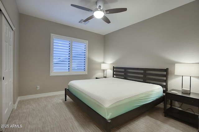 carpeted bedroom with baseboards, visible vents, ceiling fan, and a closet