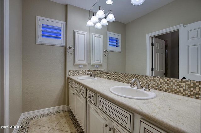 full bathroom featuring baseboards, a sink, tile patterned flooring, and double vanity