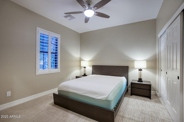 bedroom with visible vents, a closet, baseboards, a ceiling fan, and carpet