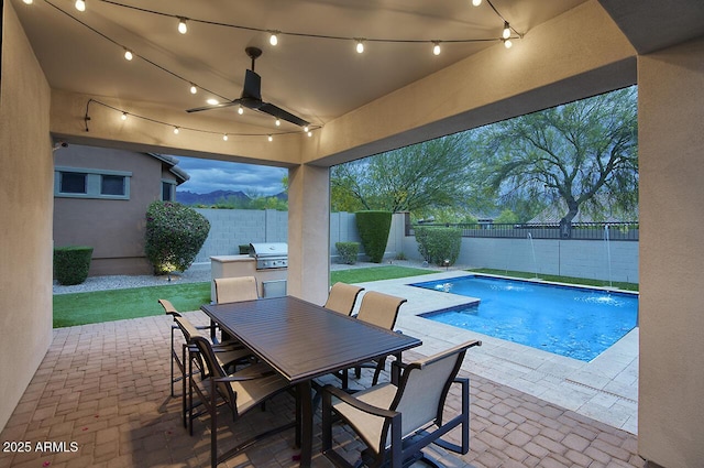 view of pool featuring a grill, a patio, a fenced backyard, a fenced in pool, and a ceiling fan
