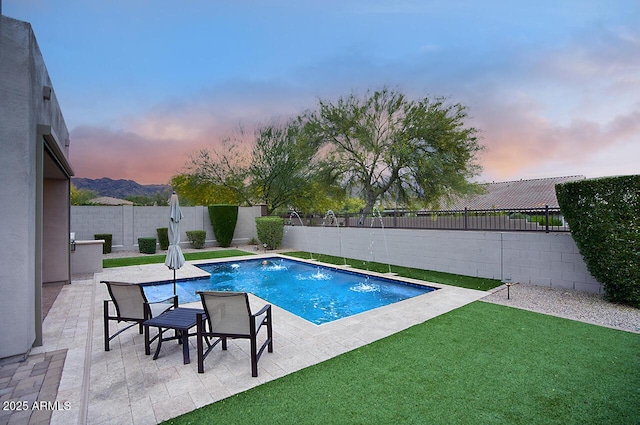 view of swimming pool with a fenced in pool, a fenced backyard, a patio area, and a yard