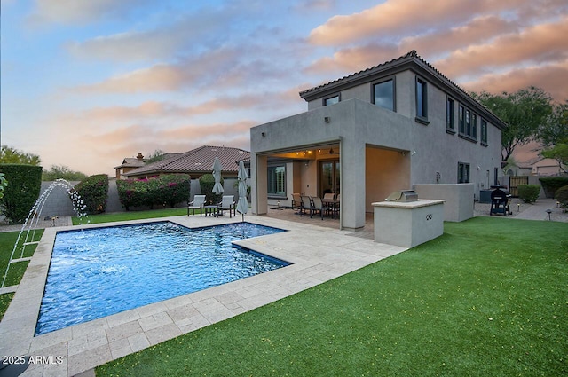 back of house with a lawn, fence, and a patio area