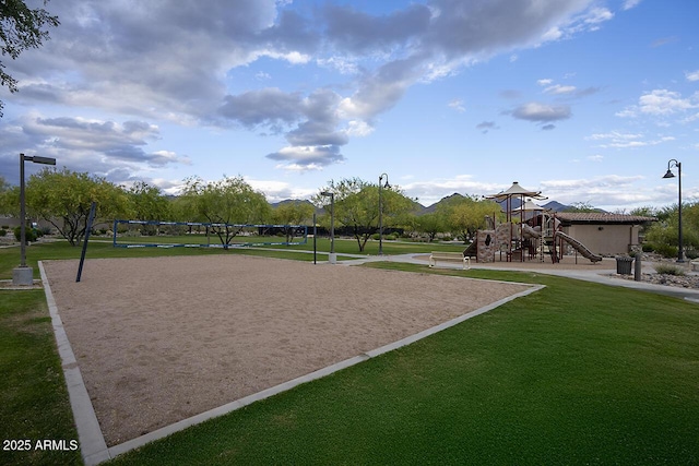 view of home's community with a lawn, volleyball court, and playground community