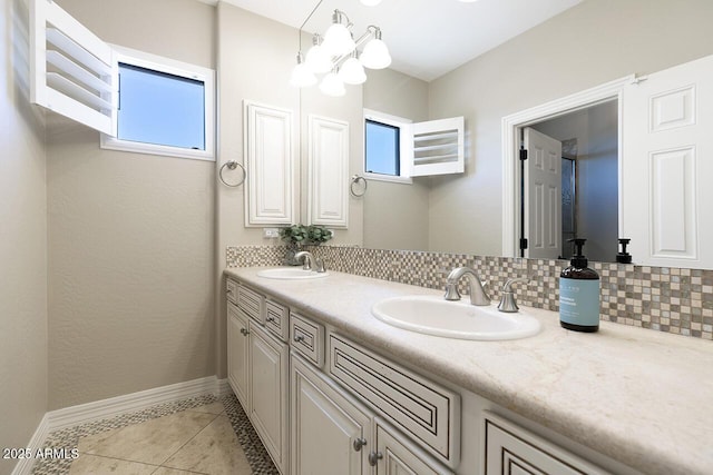 18515 N 97th Way, Scottsdale, AZ 85255 - bathroom with baseboards, tile patterned floors, double vanity, a chandelier, and tasteful backsplash