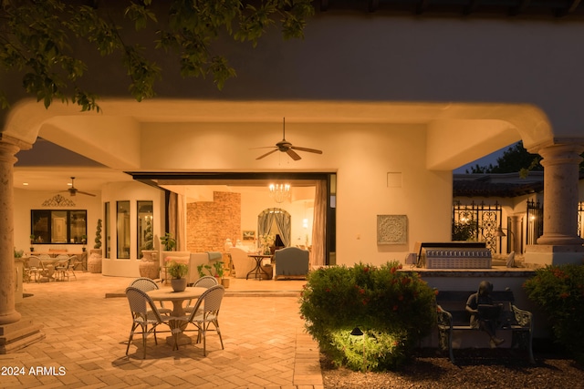 patio at twilight featuring ceiling fan and french doors