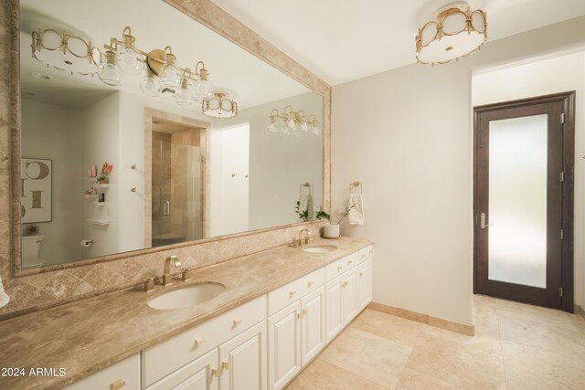 bathroom with vanity, an enclosed shower, and tile patterned floors