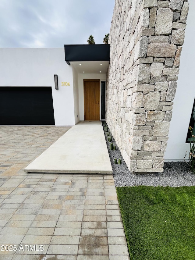 property entrance featuring stucco siding