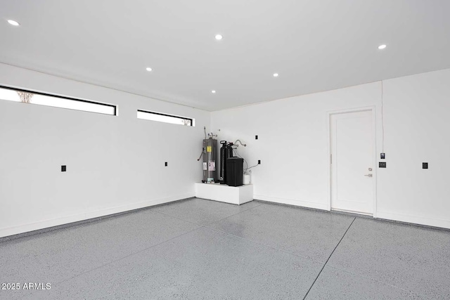 garage featuring water heater and recessed lighting