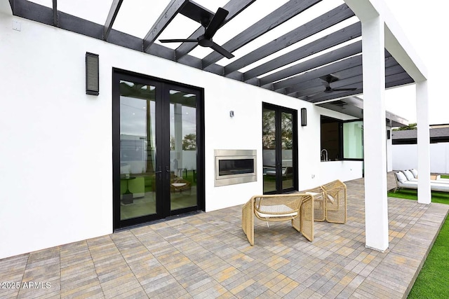 view of patio with french doors and a ceiling fan