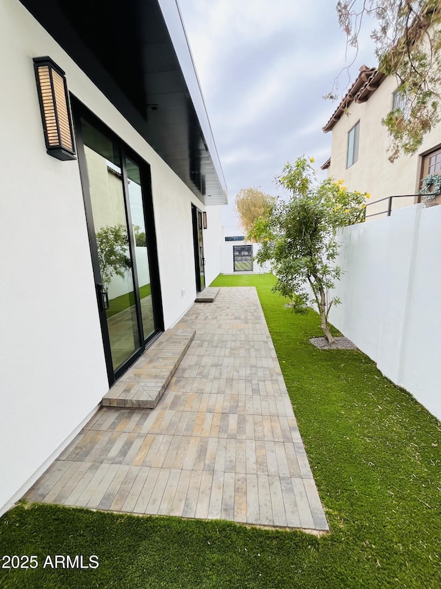 view of patio / terrace featuring fence