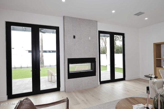 doorway featuring french doors, light wood-style flooring, visible vents, and recessed lighting