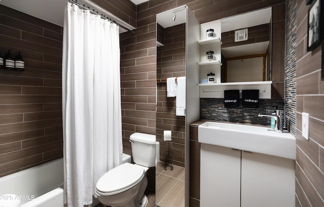 full bathroom featuring shower / bath combo with shower curtain, backsplash, tile walls, vanity, and toilet