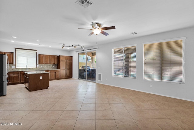 8710 N 182nd Ave, Waddell, AZ 85355 - interior space with ceiling fan, light countertops, open floor plan, a kitchen island, and visible vents
