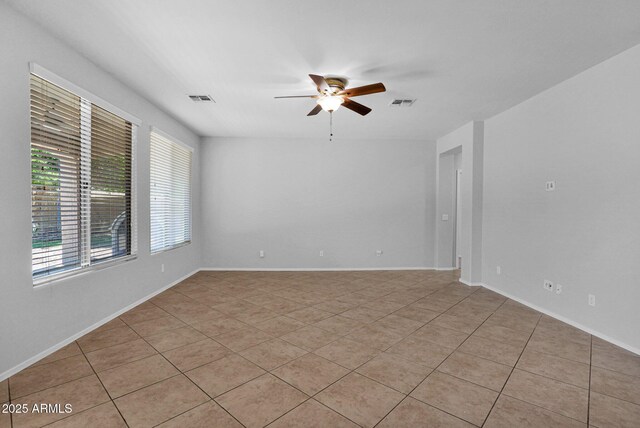 8710 N 182nd Ave, Waddell, AZ 85355 - spare room with baseboards, ceiling fan, visible vents, and light tile patterned floors
