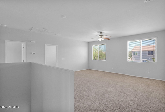 8710 N 182nd Ave, Waddell, AZ 85355 - spare room with light colored carpet, baseboards, ceiling fan, and visible vents
