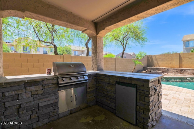 8710 N 182nd Ave, Waddell, AZ 85355 - view of patio / terrace with an outdoor kitchen, a fenced backyard, and grilling area