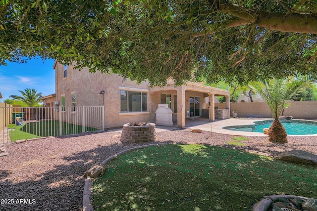 8710 N 182nd Ave, Waddell, AZ 85355 - back of house with stucco siding, a fenced backyard, a fenced in pool, a lawn, and a patio