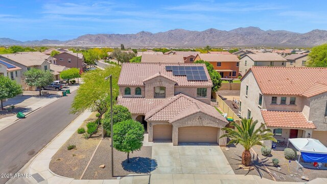 8710 N 182nd Ave, Waddell, AZ 85355 - view of front of house featuring a garage, stucco siding, a tiled roof, and a residential view