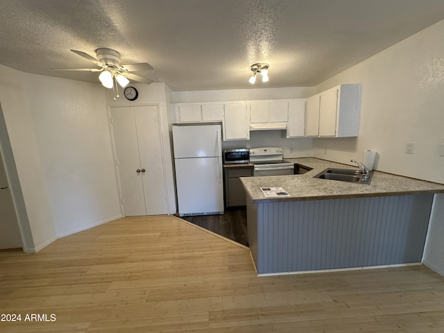 kitchen with range with electric cooktop, sink, white refrigerator, kitchen peninsula, and white cabinets