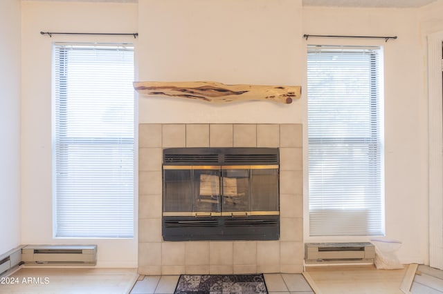 room details featuring a tile fireplace and baseboard heating