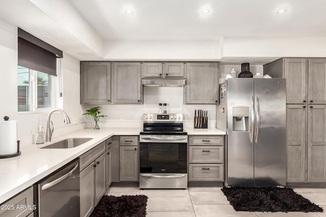 kitchen featuring sink, stainless steel appliances, and light tile patterned floors