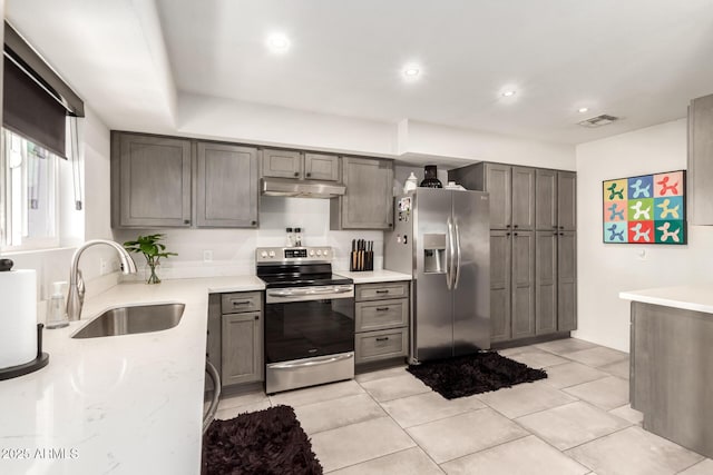 kitchen with sink, gray cabinets, stainless steel appliances, and light tile patterned flooring