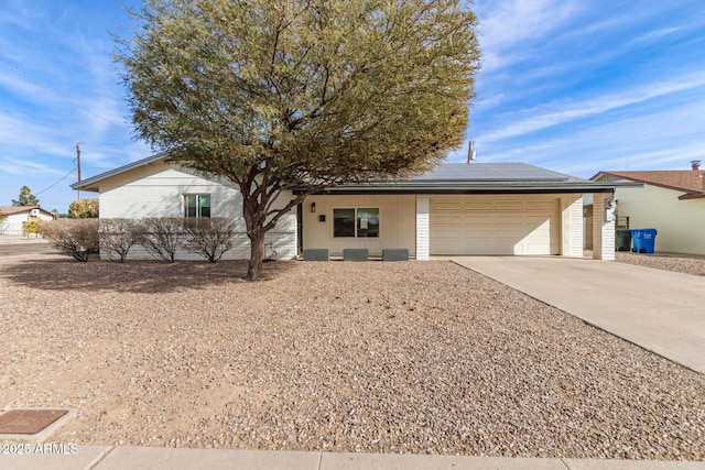 view of front of home with a garage and solar panels