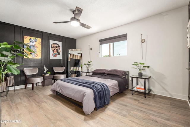 bedroom with ceiling fan and light hardwood / wood-style floors