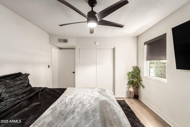 bedroom with ceiling fan and light hardwood / wood-style floors