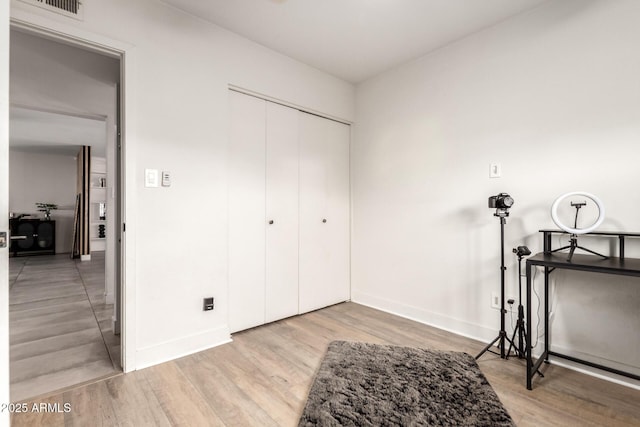 bedroom featuring a closet and light wood-type flooring